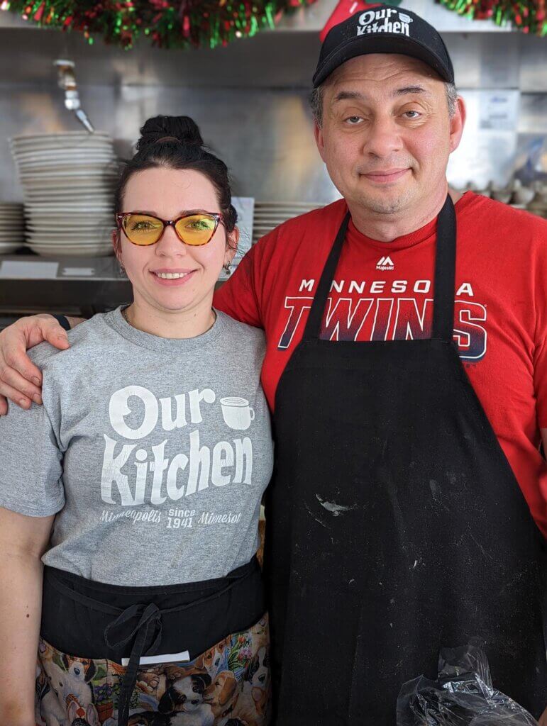 Image: A man and a woman stand together in a restaurant kitchen